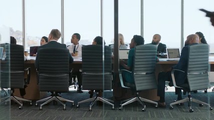 business woman team leader meeting with colleagues in boardroom discussing ideas planning strategy  - Powered by Adobe