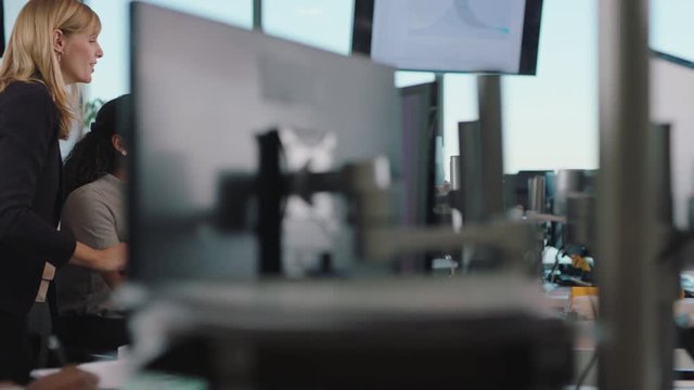 business woman team leader meeting with colleagues using computer pointing at screen office manager sharing ideas helping coworkers discussing strategy in corporate workplace