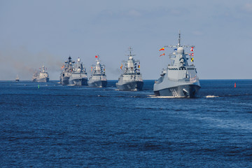 A line ahead of modern russian military naval battleships warships in the row, northern fleet and baltic sea fleet, summer sunny day