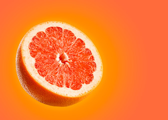 Grapefruit closeup isolated on orange background.