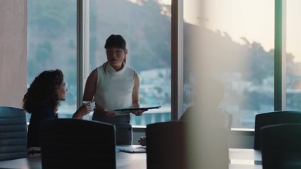 business people working late asian team leader woman meeting with colleagues discussing project manager sharing ideas on tablet computer group of executives brainstorming in office at sunset - Powered by Adobe