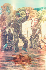 smiling young man and woman in full paintball gear having fun af