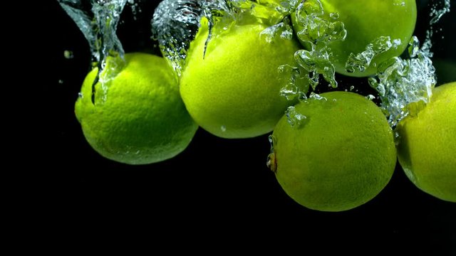 Super slow motion of falling lime pieces into splashing water. Filmed on high speed cinema camera, 1000 fps.