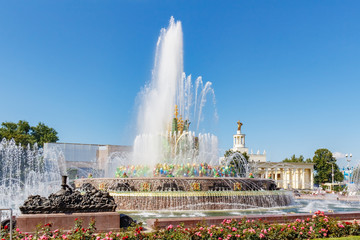 Stone Flower Fountain in VDNH park in Moscow against blue sky at sunny summer day. Exhibition of...