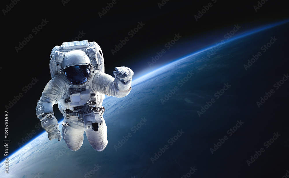 Poster astronaut in the outer space over the planet earth. abstract wallpaper. spaceman. black bakground. e