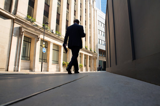 Rear view of man in suit walking on street