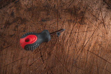 Phillips screwdriver on wooden background