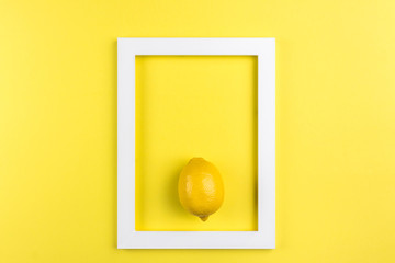 Creative summer layout made of lemon on yellow background. Minimal summer exotic concept with copy space. White border arrangement background.