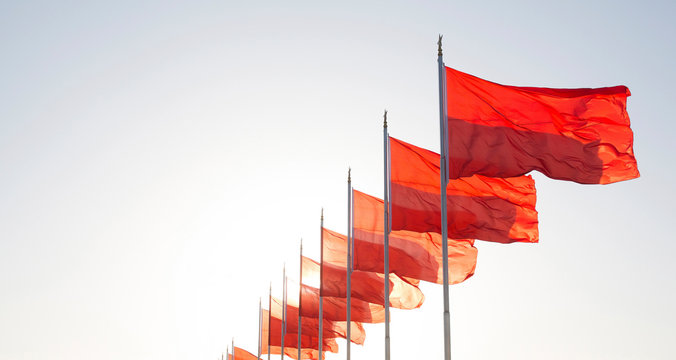 View of red flags fluttering in sky