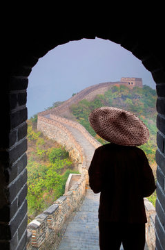 Rear view of man in hat standing at arched doorway