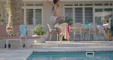 funny little boy jumping in swimming pool splashing enjoying cool water on sunny day child having fun swim on summer vacation at holiday home with excited dog running playfully 4k - Powered by Adobe