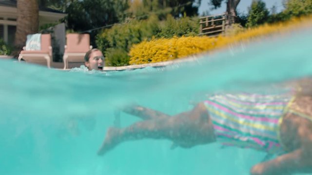 mother swimming with children in pool happy family enjoying summertime having fun splashing in cool water on sunny day underwater view 4k
