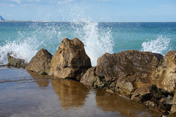 Sea wave splash at the breakwater on the beach of the Romanian resort.