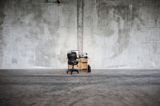 Empty desk and chair in office space - Powered by Adobe