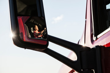 Reflection of woman in rear view mirror