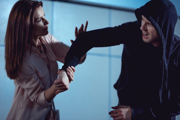 beautiful woman fighting with thief in underpass