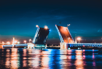 Fototapeta na wymiar A drawbridge of Saint Petersburg at night and lights reflected in water. Dvortsoviy Palace bridge and the Neva river. White nights. Famous sight in the city of Russia. Beautiful bridge view
