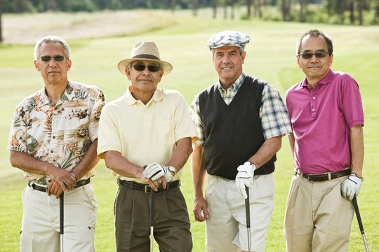 Portrait of golfers with golf club standing on golf course