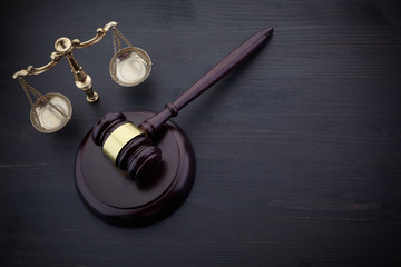 Judges Gavel And Scale Of Justice On The Black Table Background. Law Concept.