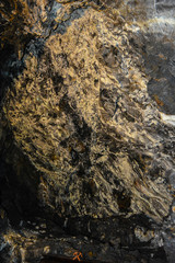 Rock face of a copper mine with a copper