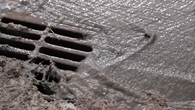 Melted water flows down through the manhole cover