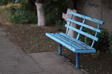 old shabby blue bench in the countryside
