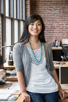 Portrait of smiling woman standing in office