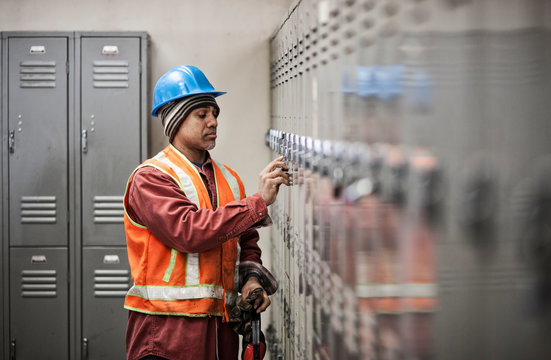 Worker getting into his locker in locker room