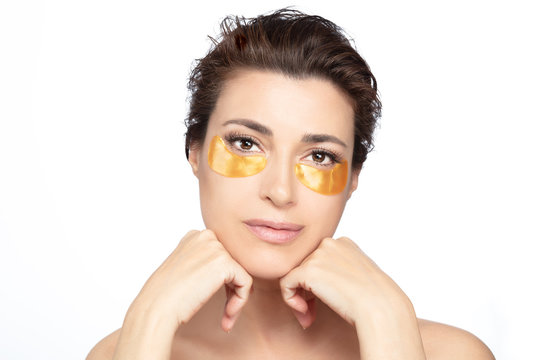 Eye skin care. Woman with under eyes collagen pads isolated on white