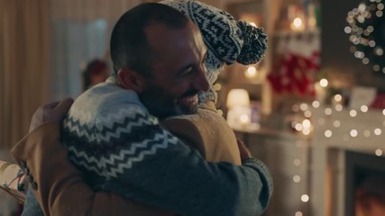 elderly mother visiting son for christmas eve hugging bringing presents for family enjoying festive holiday celebration together on winter evening at home 4k footage