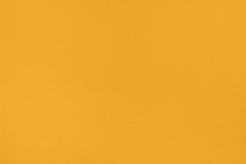 Saturated mellow yellow colored low contrast Concrete textured background with roughness and...