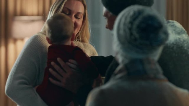 grandparents visiting for christmas eve hugging family and baby enjoying festive celebration reunion at home 4k footage