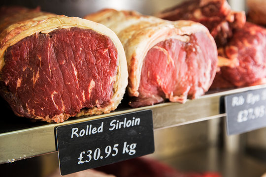 Close up of piece of rolled beef sirloin meat on metal shelf