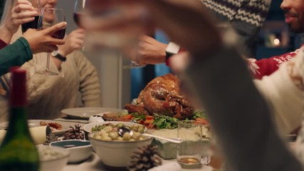 christmas family dinner making toast celebrating festive season sharing homemade feast with friends enjoying  holiday celebration at home 4k footage