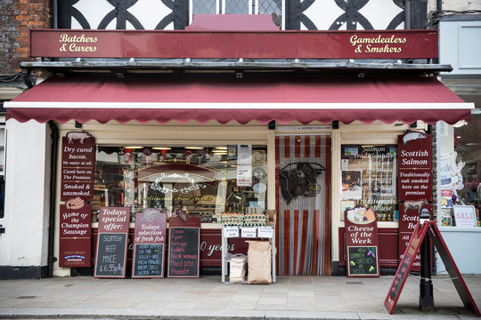 Exterior view of butcher shop with blackboards
