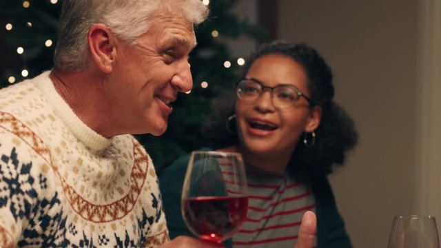 happy family christmas dinner sharing delicious homemade meal at festive celebration sitting at table enjoying feast celebrating holiday at home with friends 4k footage