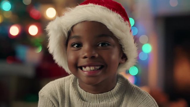 portrait little african american girl celebrating christmas wearing hat smiling enjoying festive holiday having fun evening at home 4k 