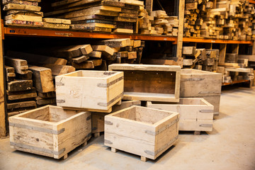 Shelves with wooden planks and stack of wooden crates in warehouse