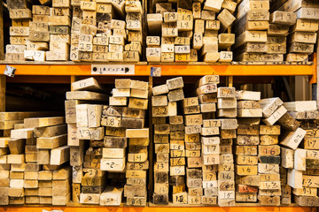 Wooden planks stacked on shelves in warehouse