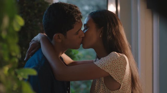 happy young couple first kiss beautiful teenage girl kissing boyfriend outside home enjoying romantic evening date 4k footage