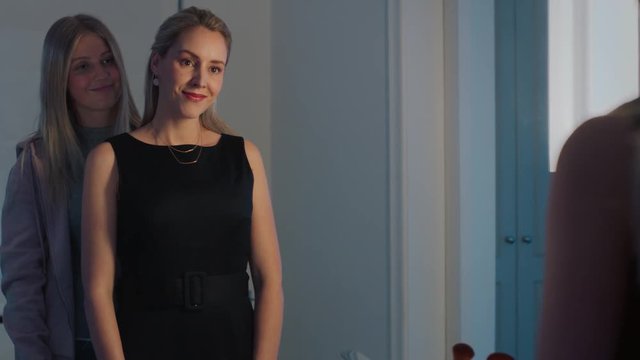 beautiful mother getting ready for evening date wearing stylish fashion with teenage girl helping mom prepare looking in mirror 4k