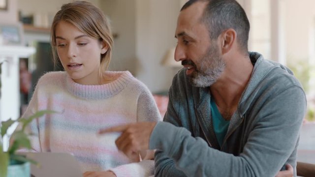 father and daughter high five using laptop computer dad helping teenage girl with homework successful problem solving 4k