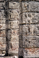 Carved stone columns with Mayan images in Chichen Itza, Mexico.