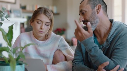 father and daughter using laptop computer dad helping teenage girl with homework at home teaching problem solving parent supporting education 4k - Powered by Adobe