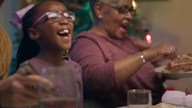 little african american girl enjoying christmas dinner with family eating delicious homemade meal sharing holiday feast at home 4k footage