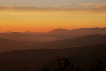 Sunset; Silhouettes of the hills on the horizon -