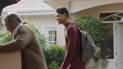 young man moving out of house leaving for college packing luggage in car hugging parents goodbye mother and father embracing son farewell 4k footage - Powered by Adobe