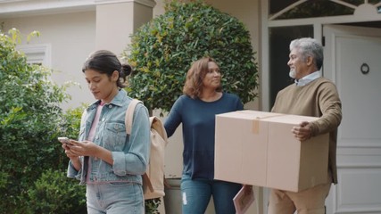 young girl moving out of house leaving for college packing luggage in car hugging parents goodbye mother and father embracing daughter farewell 4k footage