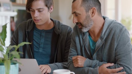 father and son high five using laptop computer dad helping teenage boy with homework successful problem solving 4k - Powered by Adobe