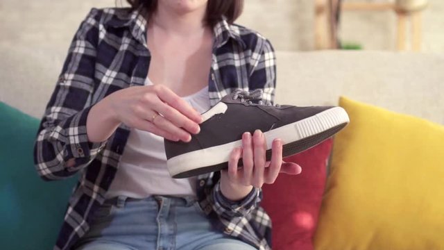 young woman inserts an orthopedic insole into the shoe close up